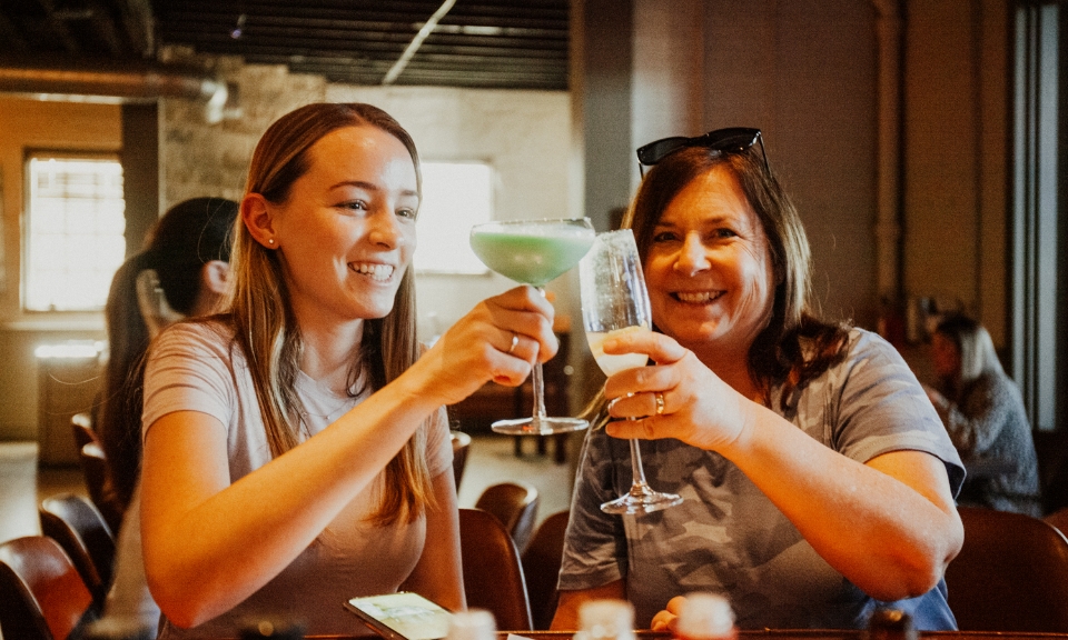 Two female diners cheers their glasses